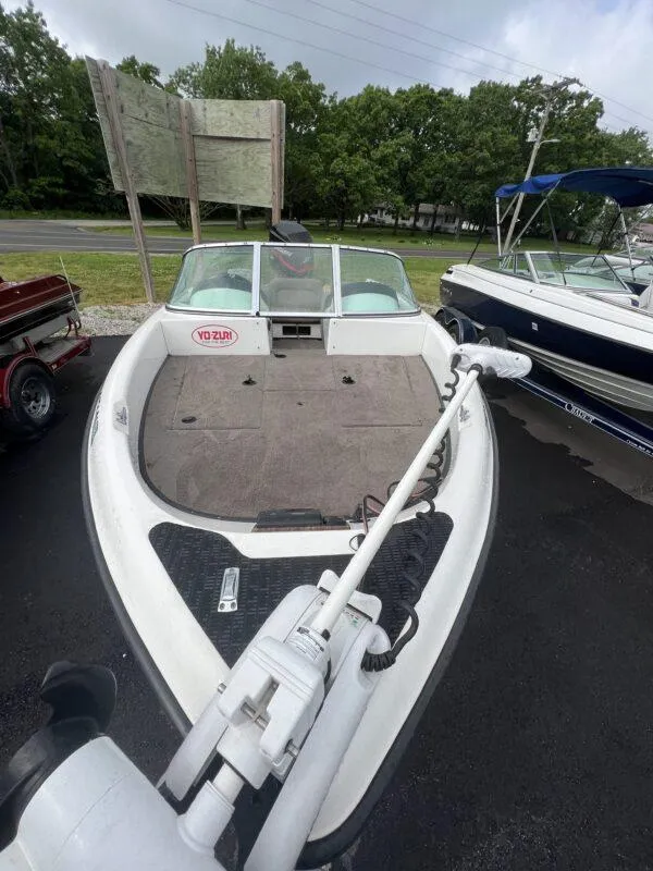 Slide: The Image of 2005 Triton 190 FS boat with trolling motor, parked on asphalt. - 3