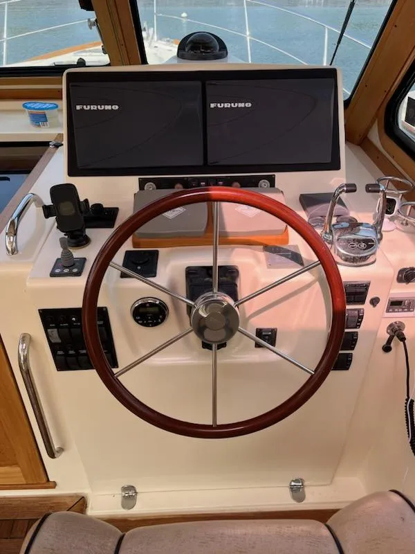 Slide: The Image of 2006 Sabre 38 Hard Top Express helm with dual Furuno displays and wooden steering wheel. - 11