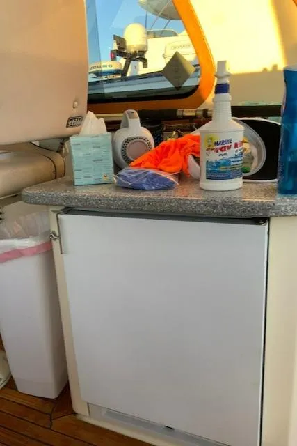 Slide: The Image of Interior of 2006 Sabre 38 Hard Top Express with cleaning supplies on counter. - 15