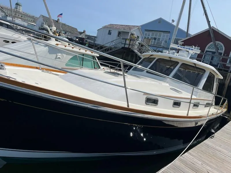 Slide: The Image of 2006 Sabre 38 Hard Top Express yacht docked at a marina. - 22