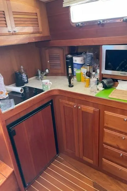 Slide: The Image of 2006 Sabre 38 Hard Top Express yacht kitchen with wooden cabinets and modern appliances. - 4
