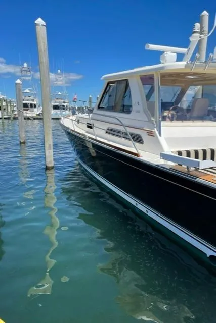 Slide: The Image of 2006 Sabre 38 Hard Top Express yacht docked at marina on a sunny day. - 5