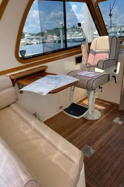 Slide: The Image of Interior of 2006 Sabre 38 Hard Top Express with helm seat and navigation table. - 7