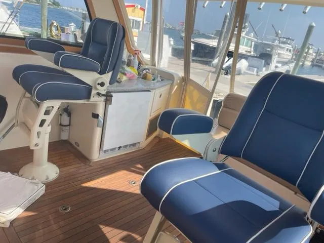 Slide: The Image of Interior of 2006 Sabre 38 Hard Top Express with blue seating and wooden flooring. - 8