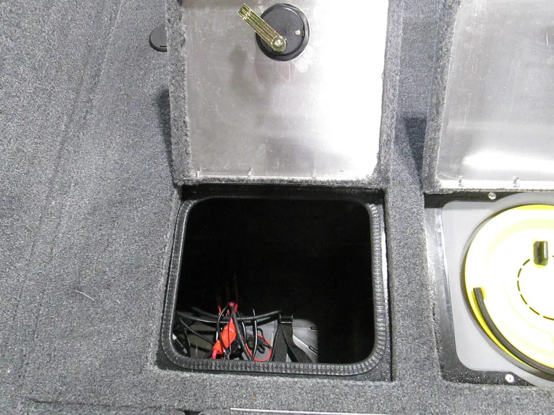 Slide: The Image of 2023 Tracker Pro Guide V-175 WT storage compartment with battery cables. - 14
