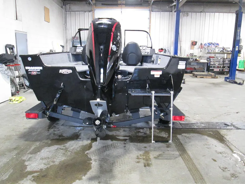 Slide: The Image of 2023 Tracker Pro Guide V-175 WT boat in a garage, rear view. - 3