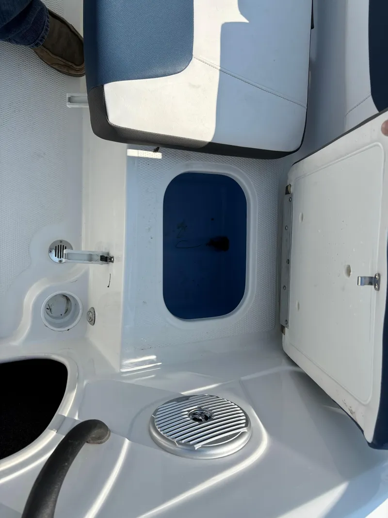 Slide: The Image of 2023 Tahoe 185 S boat interior with storage compartment and seating. - 13