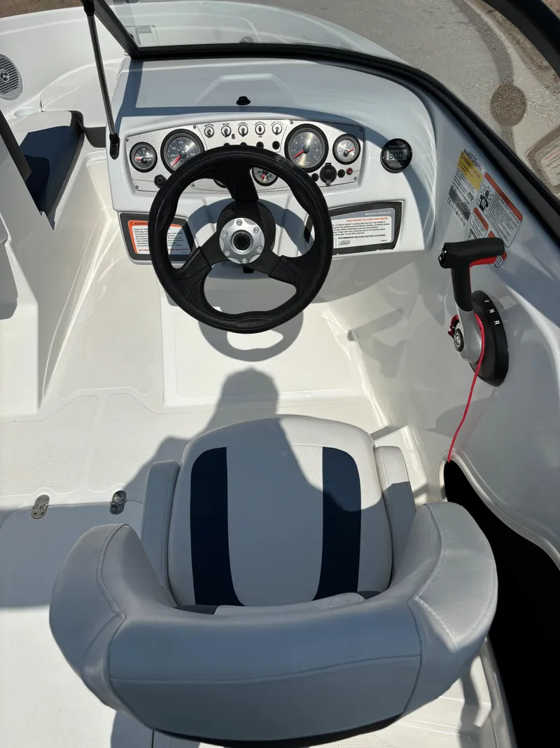 Slide: The Image of 2023 Tahoe 185 S boat cockpit with steering wheel and control panel. - 14