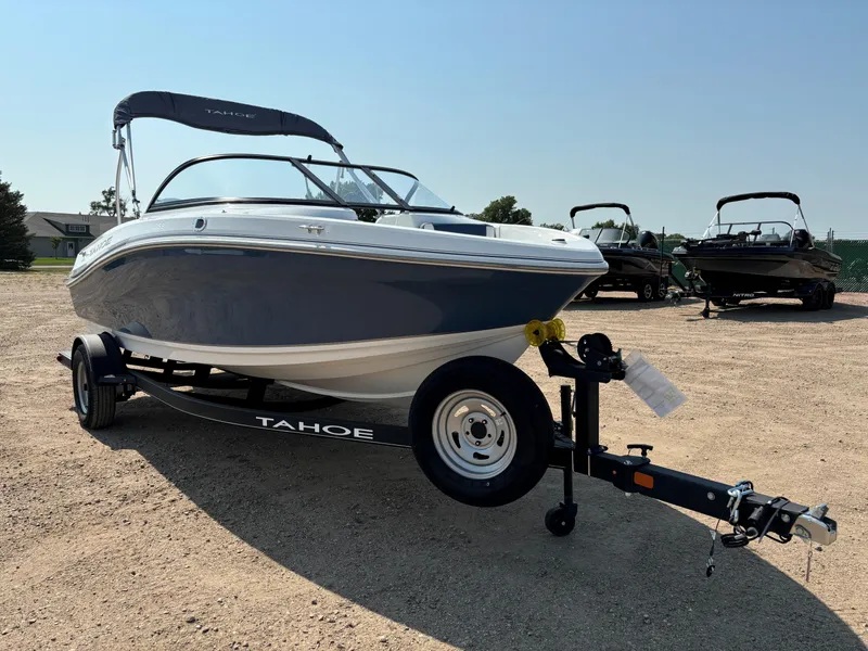 Slide: The Image of 2023 Tahoe 185 S boat on trailer in outdoor setting. - 2