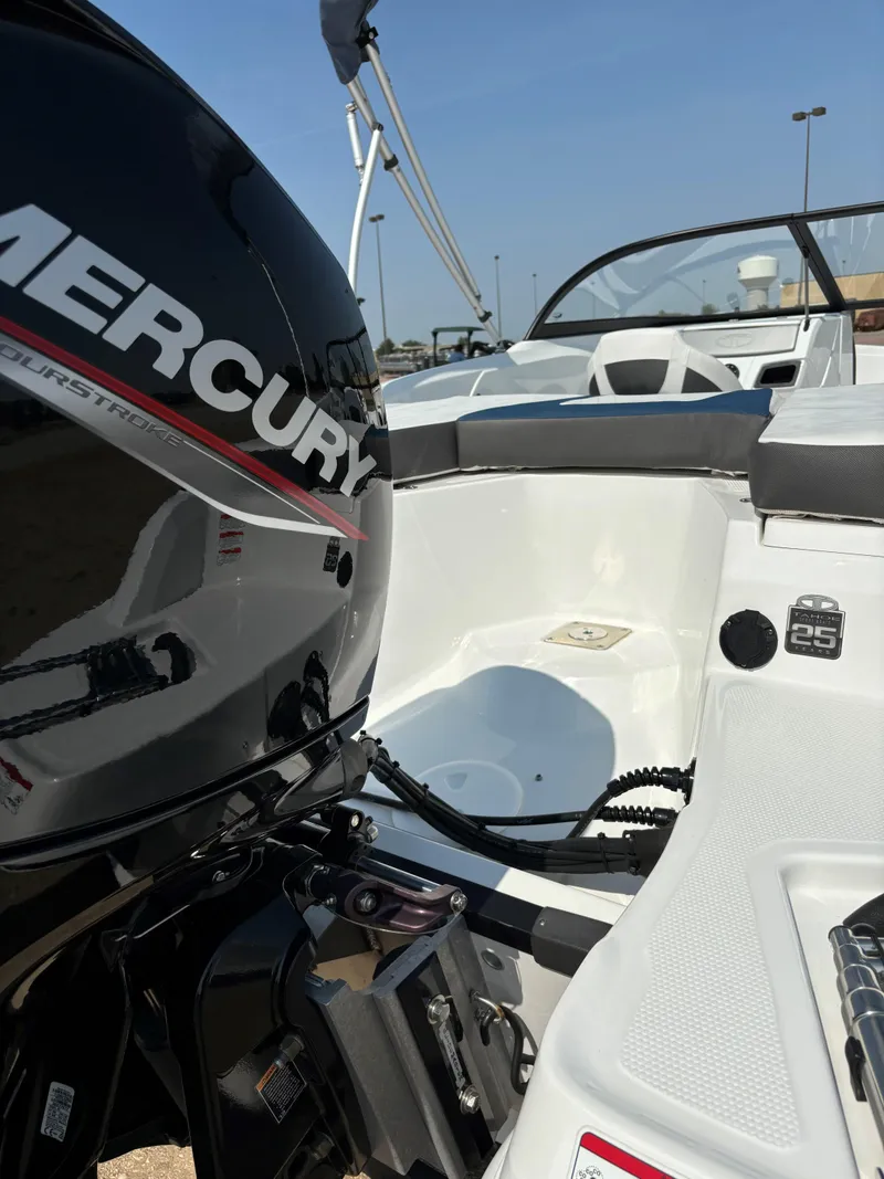 Slide: The Image of 2023 Tahoe 185 S boat with Mercury engine, white interior, and sleek design. - 7
