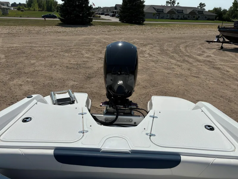 Slide: The Image of 2023 Tahoe 185 S boat with outboard motor on a sandy lot. - 8