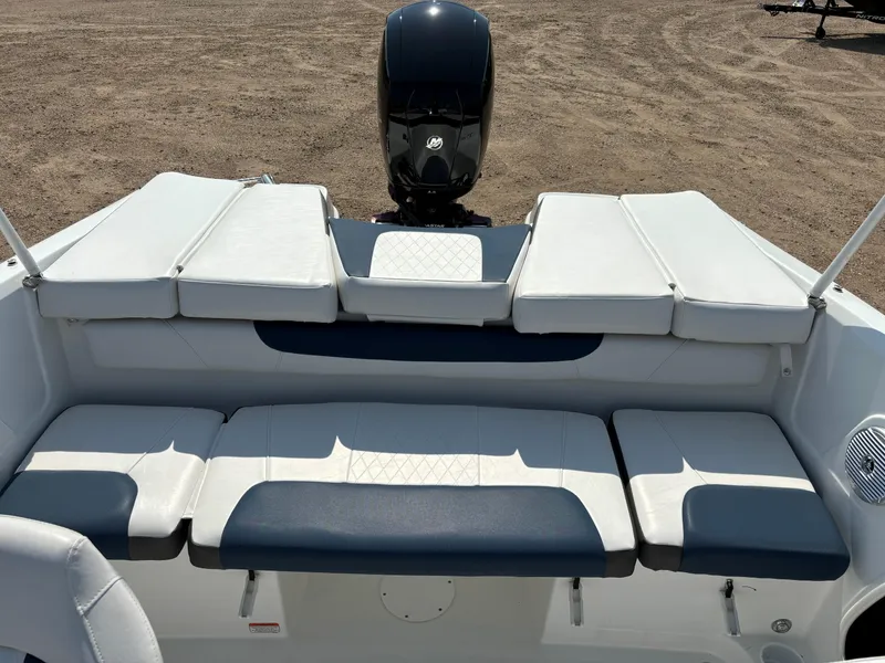 Slide: The Image of 2023 Tahoe 185 S boat interior with cushioned seating and outboard motor. - 9