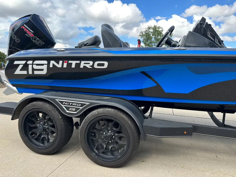 Slide: The Image of 2023 Nitro Z19 Pro boat with blue and black design on a trailer. - 3