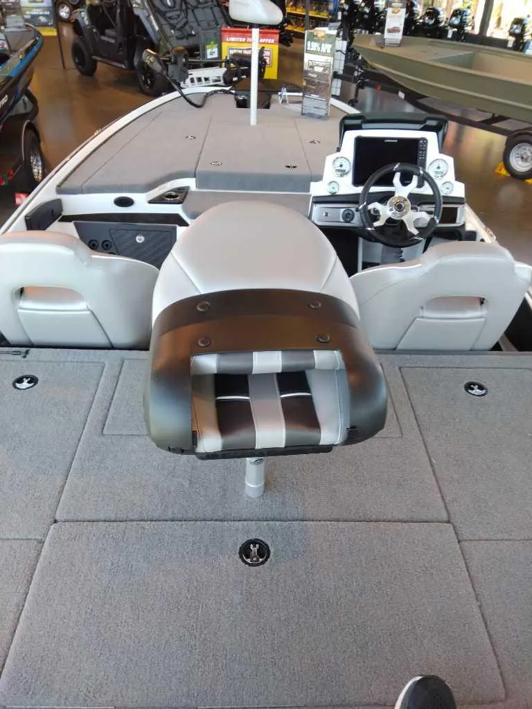 Slide: The Image of 2023 Nitro Z20 fishing boat interior with steering console and seating. - 11
