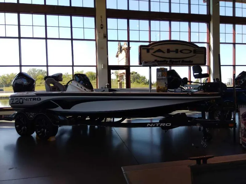 Slide: The Image of 2023 Nitro Z20 boat displayed indoors with large windows in the background. - 12