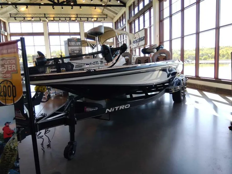 Slide: The Image of 2023 Nitro Z20 fishing boat displayed indoors with large windows. - 8