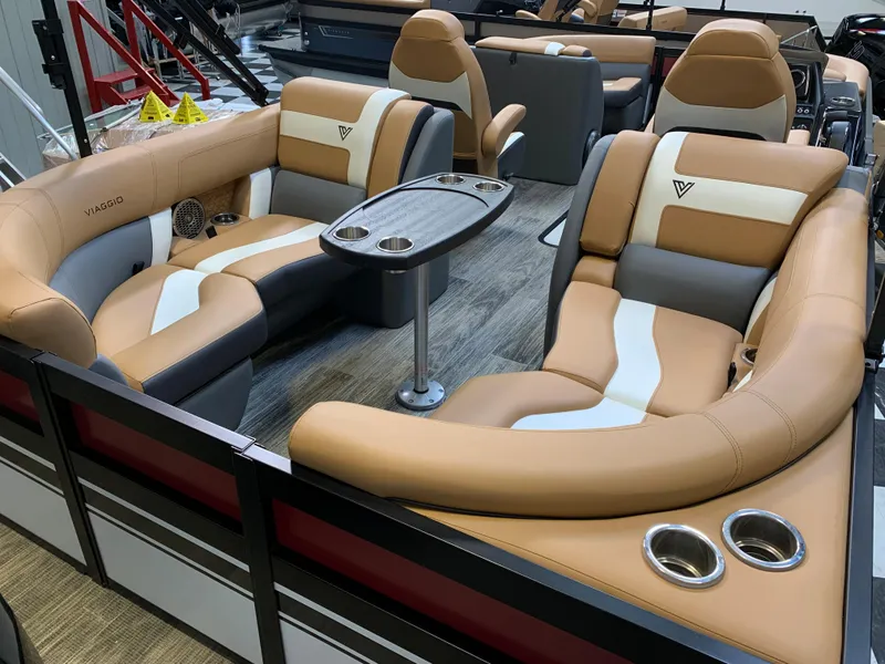 Slide: The Image of 2023 Viaggio Diamante 23 U luxury pontoon boat interior with tan and white seating. - 5