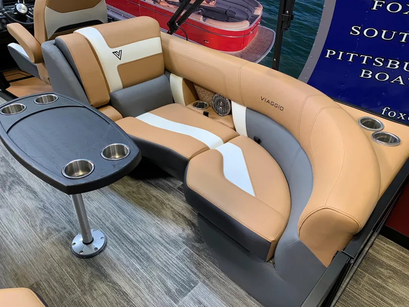 Slide: The Image of 2023 Viaggio Diamante 23 U boat interior with tan and gray seating and cup holders. - 7