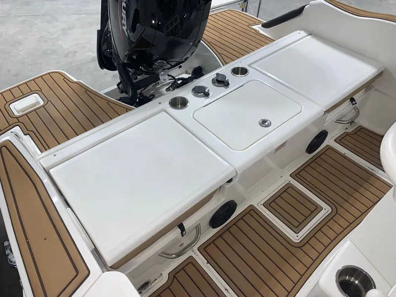 Slide: The Image of 2024 Bayliner Trophy 20 CC boat deck with wood accents and storage compartments. - 10
