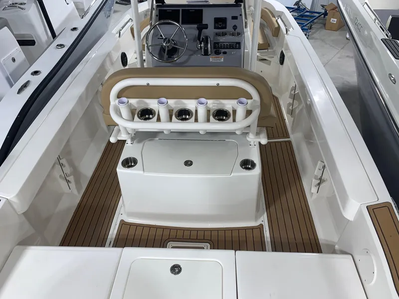 Slide: The Image of 2024 Bayliner Trophy 20 CC center console boat with teak flooring and rod holders. - 5