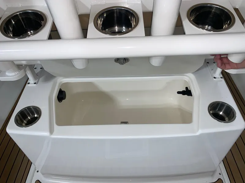Slide: The Image of Bayliner Trophy 20 CC 2024 fishing rod holders and storage compartment. - 7