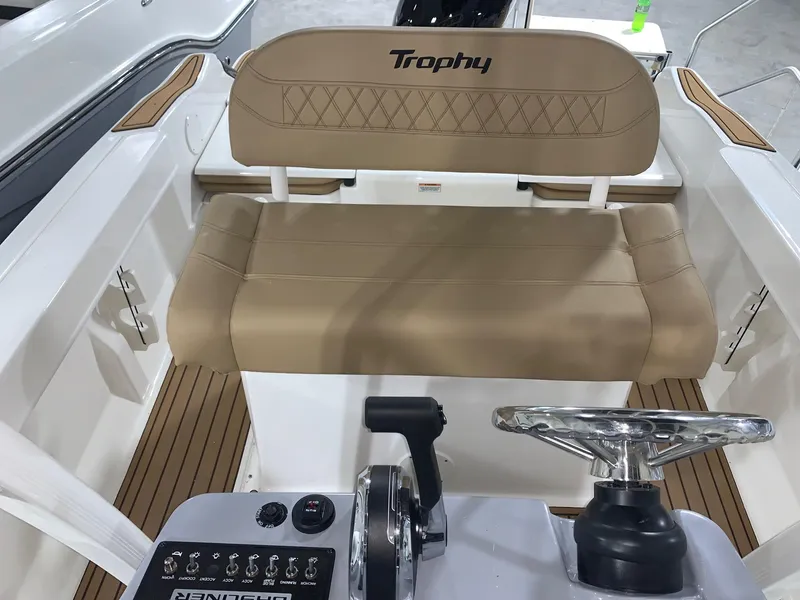 Slide: The Image of 2024 Bayliner Trophy 20 CC boat interior with tan seating and control panel. - 12