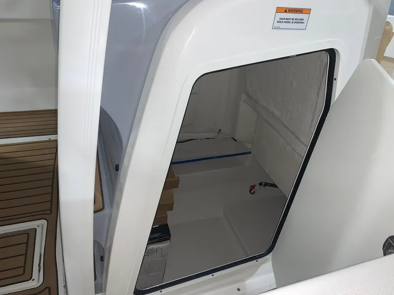 Slide: The Image of 2024 Bayliner Trophy 20 CC cabin interior with wooden flooring. - 13