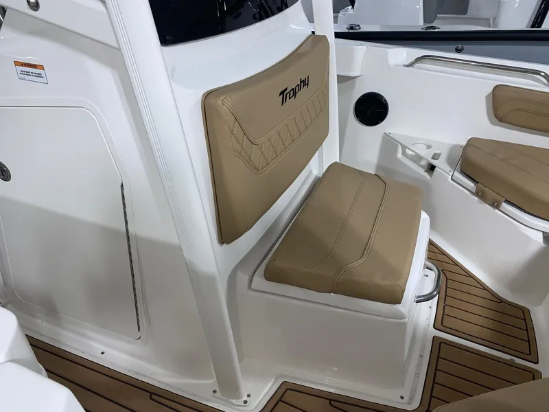 Slide: The Image of 2024 Bayliner Trophy 20 CC boat interior with tan seating and white trim. - 15