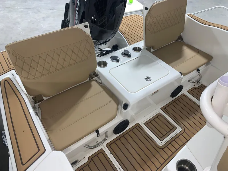 Slide: The Image of 2024 Bayliner Trophy 20 CC boat interior with tan seats and teak flooring. - 9
