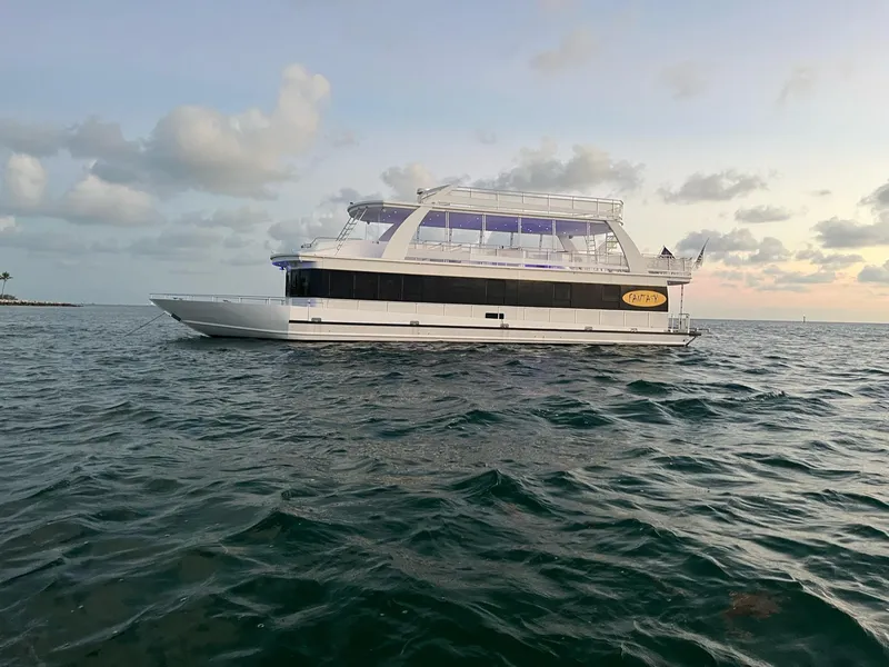 The Image of 2009 Fantasy Houseboat on open water at sunset. - 1