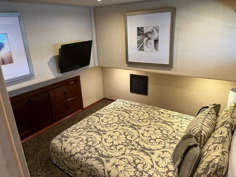 Slide: The Image of Cozy bedroom in a 2009 Fantasy Houseboat with elegant decor and wall-mounted TV. - 11