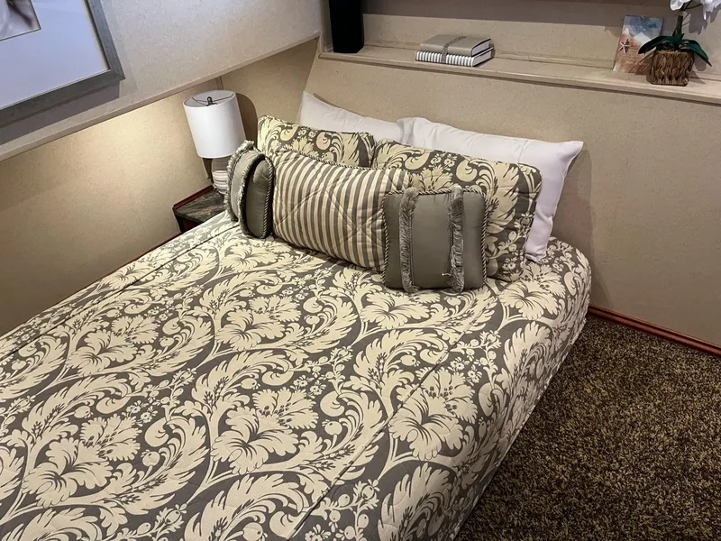 Slide: The Image of Luxurious bedroom interior in a 2009 Fantasy Houseboat with elegant bedding and decorative pillows. - 12