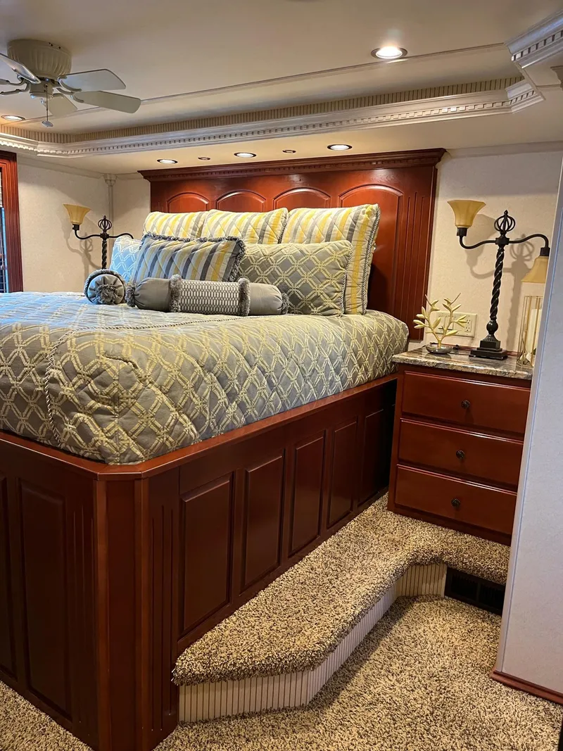 Slide: The Image of Luxurious bedroom in a 2009 Fantasy Houseboat with elegant bedding and wooden furniture. - 17