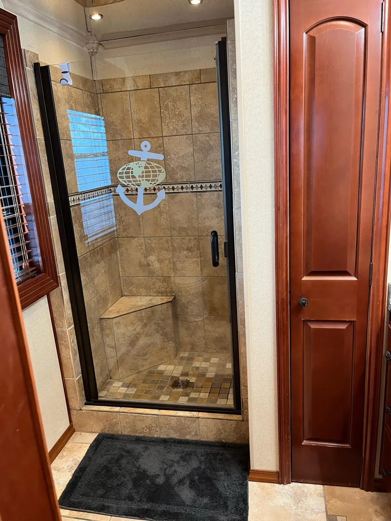 Slide: The Image of 2009 Fantasy Houseboat bathroom with tiled shower and glass door. - 19