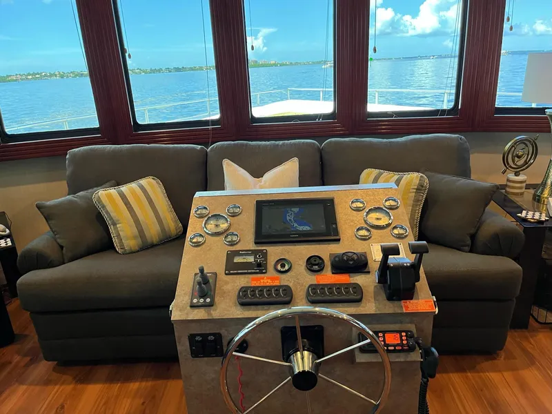 Slide: The Image of Interior of 2009 Fantasy Houseboat with control panel and sofa, overlooking serene water view. - 22