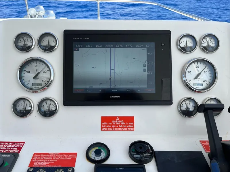 Slide: The Image of Control panel of a 2009 Fantasy Houseboat with navigation screen and gauges. - 25