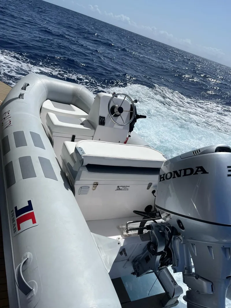 Slide: The Image of Inflatable boat with Honda motor on a 2009 Fantasy Houseboat in open sea. - 28