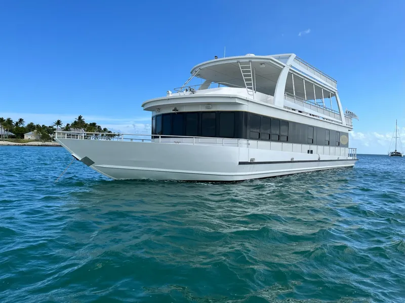 Slide: The Image of 2009 Fantasy Houseboat on clear blue water with a tropical island background. - 3