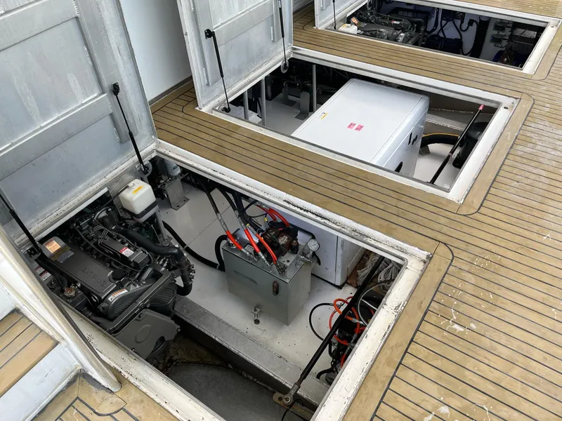 Slide: The Image of Engine compartment of a 2009 Fantasy Houseboat with open hatches showing machinery. - 35