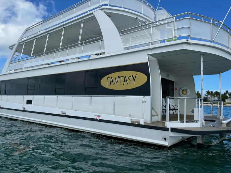 Slide: The Image of 2009 Fantasy houseboat on water with clear blue sky. - 4
