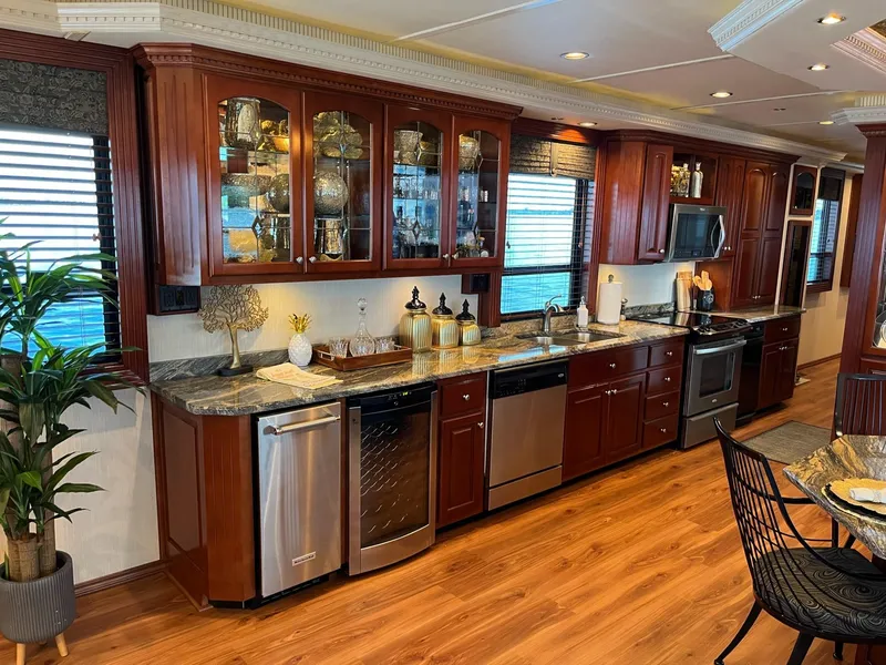 Slide: The Image of Luxurious kitchen in a 2009 Fantasy Houseboat with wooden cabinets and modern appliances. - 9
