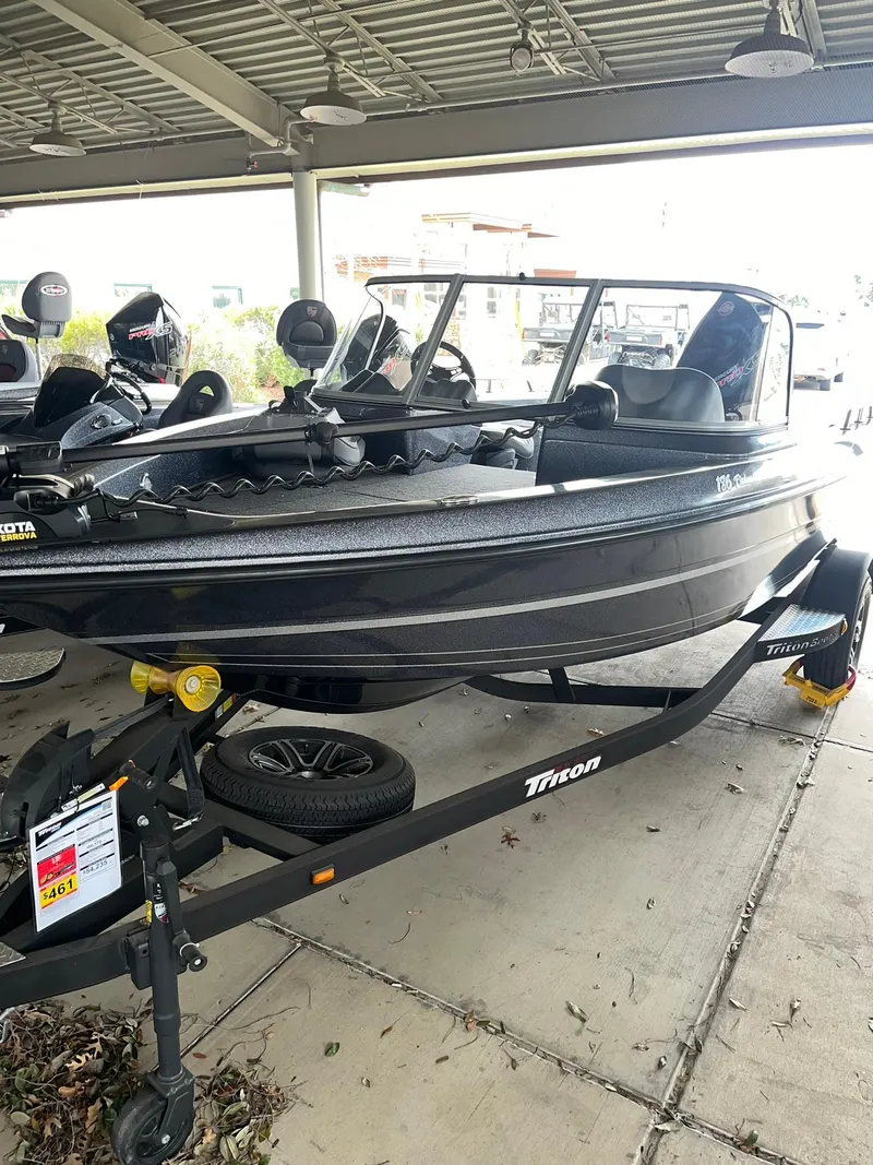 Slide: The Image of 2023 Triton 186 Fishunter boat on trailer under shelter. - 1