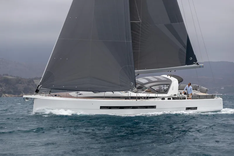 The Image of 2024 Jeanneau 55 sailing on open water with sleek design and dark sails. - 0