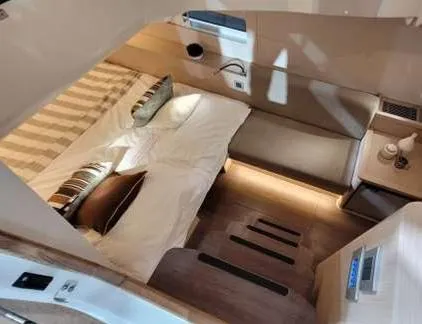 Slide: The Image of Luxurious interior cabin of 2024 Jeanneau 55 yacht with modern bedding and ambient lighting. - 14