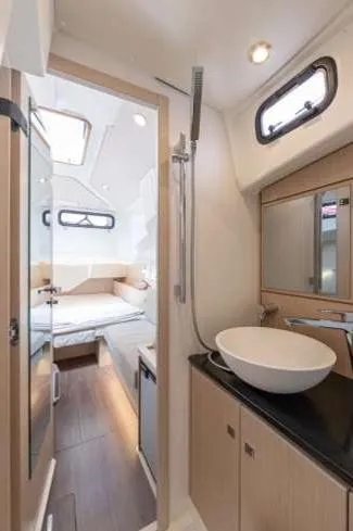 Slide: The Image of 2024 Jeanneau 55 yacht interior with modern bathroom and cozy bedroom. - 15