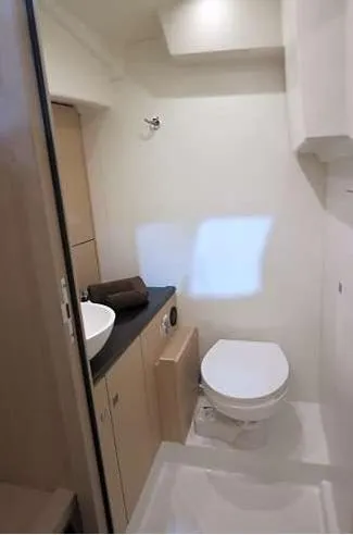Slide: The Image of 2024 Jeanneau 55 yacht bathroom with modern fixtures and compact design. - 16