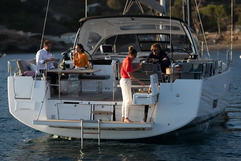 Slide: The Image of 2024 Jeanneau 55 yacht with people enjoying leisure time on deck. - 9