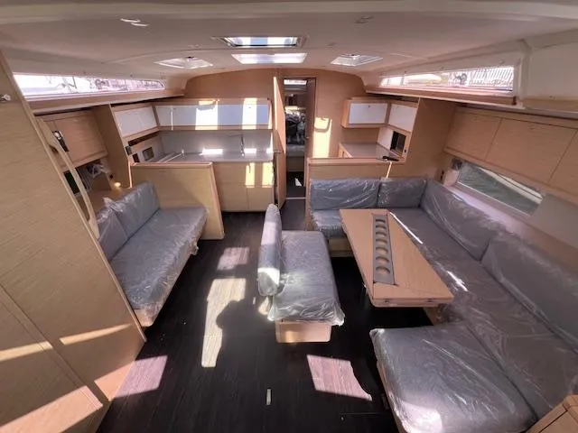 Slide: The Image of Spacious interior of 2024 Dufour 470 yacht with modern furnishings and ample seating. - 28
