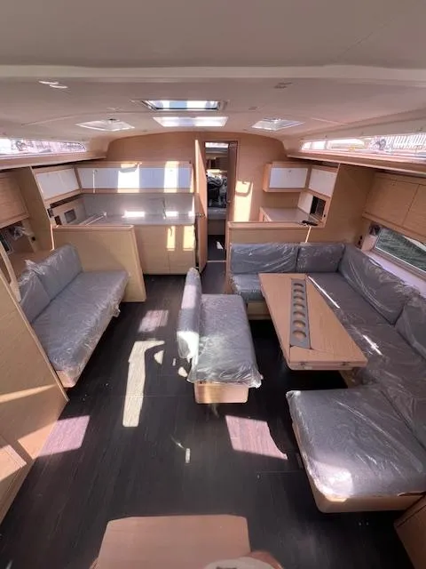 Slide: The Image of 2024 Dufour 470 yacht interior with modern seating and spacious layout. - 29