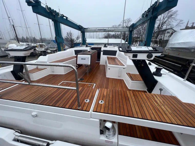 Slide: The Image of 2024 Dufour 470 sailboat with teak deck in a marina. - 3